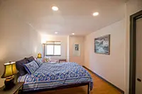 Peaceful bedroom with cozy bedding and natural light in a Northern California vacation rental in Shelter Cove.