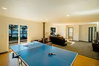 Game room with ping pong table and ocean views at a family-friendly vacation rental in Shelter Cove, CA.