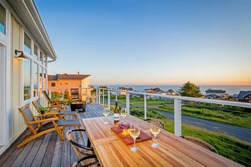 Spacious outdoor deck with fire pit and lounge seating at a vacation rental home in Shelter Cove, Northern California.