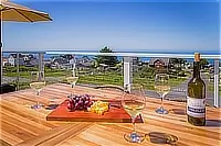 Outdoor dining table overlooking Shelter Cove and the ocean