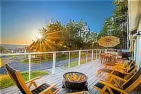 Gas fire pit and seating on the ocean-view deck at sunset