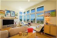 Bright living room with large windows and ocean views