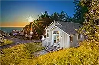 Exterior of the cottage and surrounding lawn at sunset