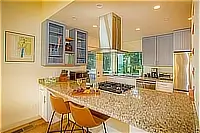 Kitchen with granite island, gas cooktop, and bar seating
