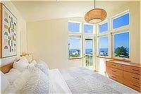 Primary bedroom with king bed and ocean views