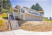 Exterior view of the cottage with stairs leading to the deck