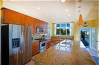 Spacious kitchen with wood cabinets, stainless steel appliances, and granite countertops.